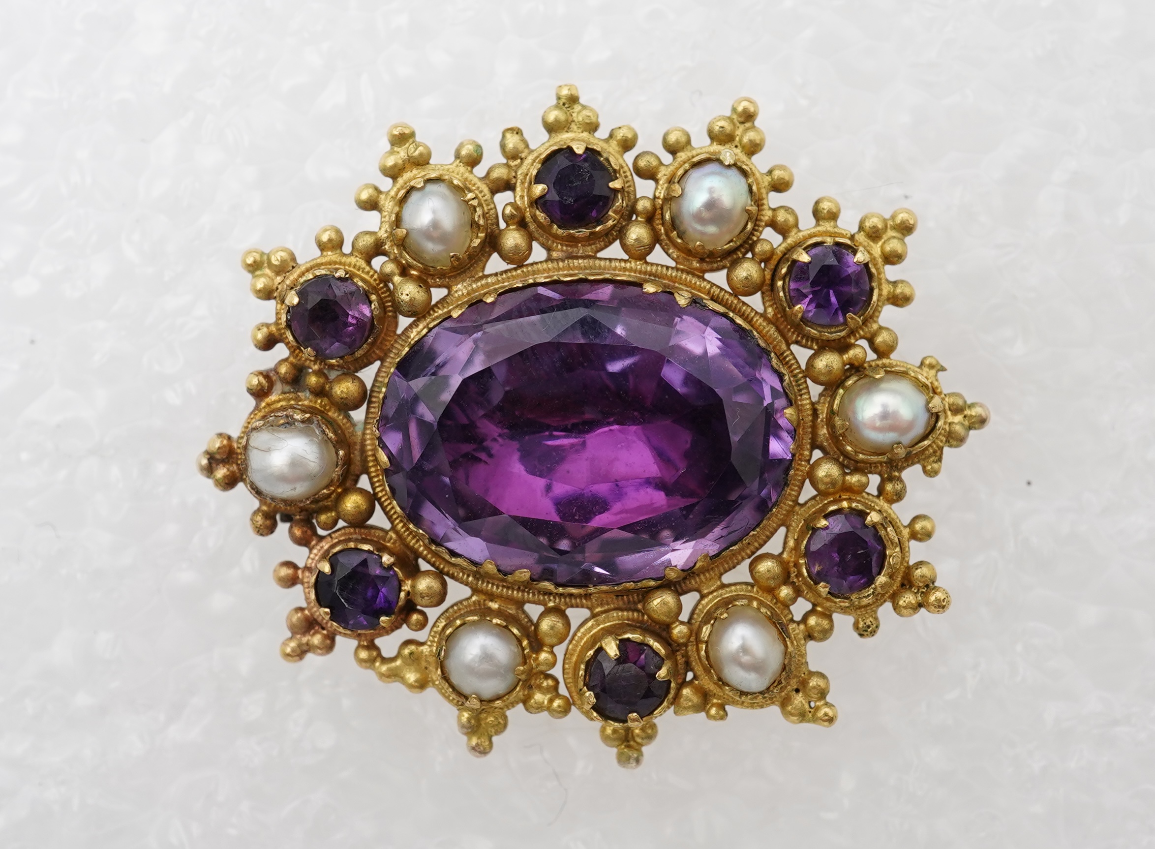 An amethyst and split pearl brooch, mid 19th century